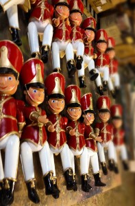 many small toy soldier ornaments in factory production