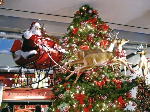 Santas sleigh and fiberglass deer flying around Christmas tree