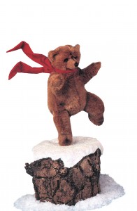 animated plush brown bear spinning on tree stump