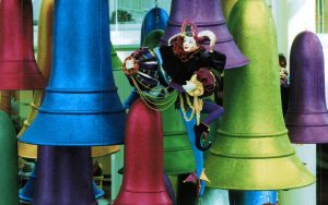 giant colorful christmas bell ornaments with hanging jester