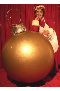 Mrs. Santa Claus with the giant gold glitter ball ornament