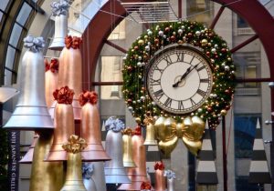 Giant Mountain Pine Wreath around Clock with metallic leaf giant bell ornaments in shopping center