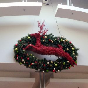 oval mountain pine wreath with red manzanita deer